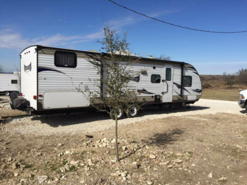 Trailer in a gravel site at Open Valley RV Park