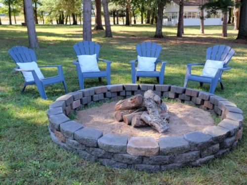 Chairs around a firepit at Whispering Pines Events & Lodging