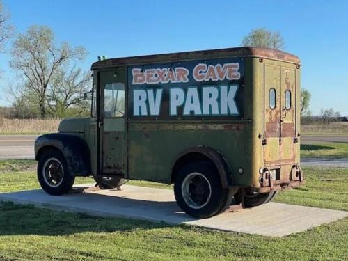 An old truck with the park name on it at BEXAR COVE RV PARK