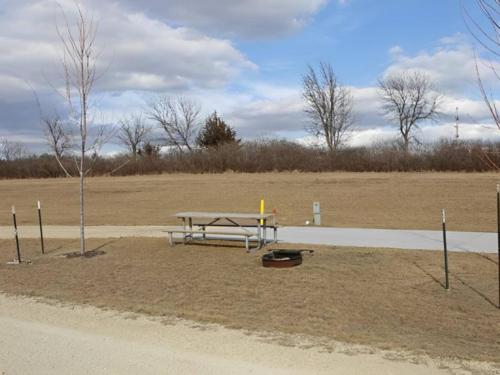 A large RV site with table and fire pit