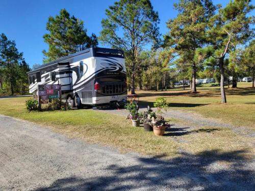 View of RV parked in a camp site at HITCHINPOST RV PARK AND CAMPGROUND