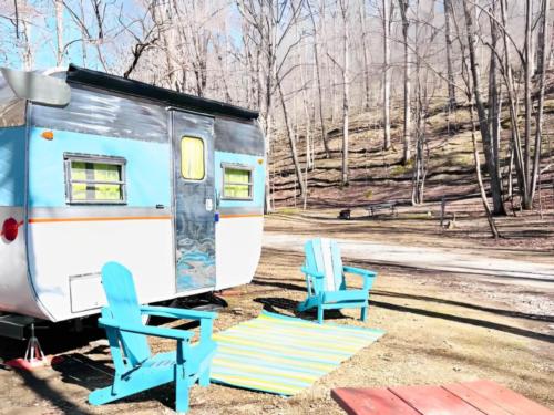Vintage trailer with colorful chairs