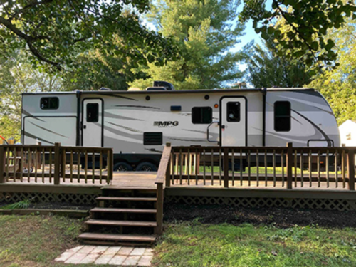 Trailer with wood deck at Cedar Lake Family Campground
