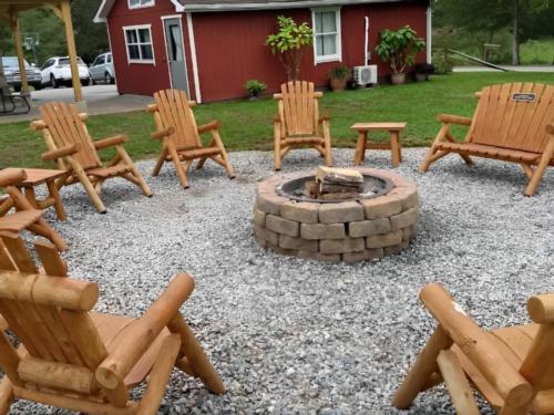 Fire pit with seating area at site Cedar Lake Family Campground