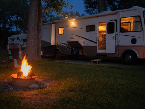 Large RV and fire pit at Rustic Oak RV Park