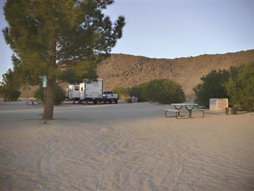 RV parked in a sandy site