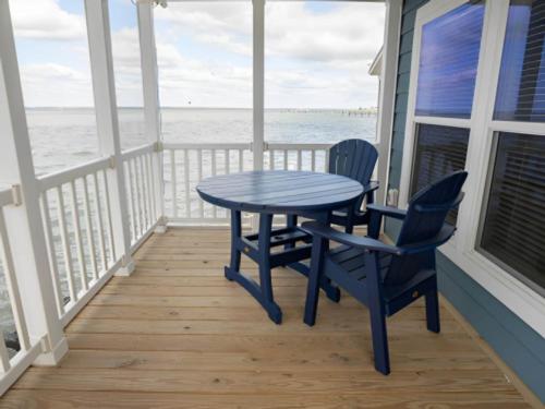 Seating area on patio with water view at BluFin Bungalows & Marina