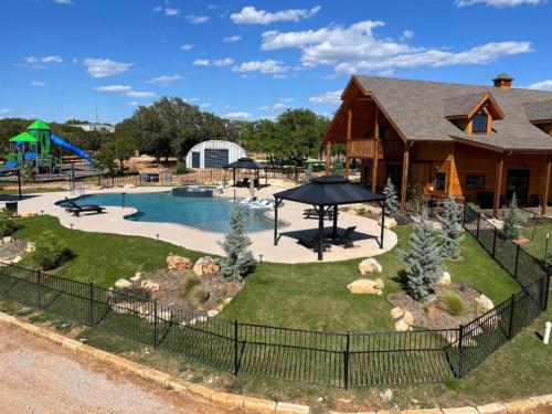 View of the pool area, playground and lodge at RIVER'S EDGE CAMPGROUND