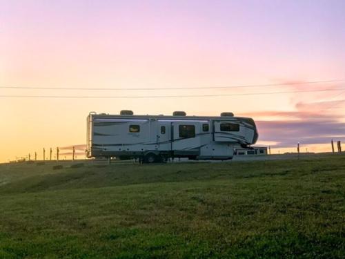 Travel trailer park at sunset at Escape With US RV Resort