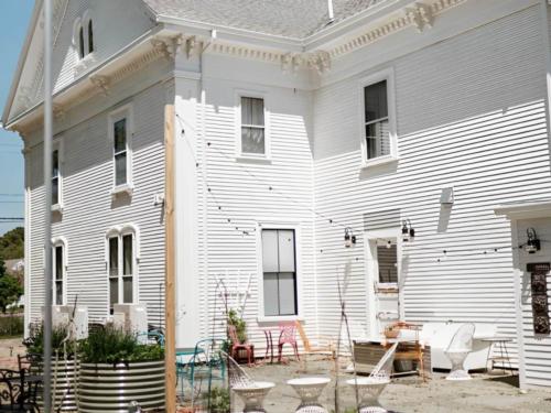 Side view of the home with seating area at The Arrival Bed & Breakfast