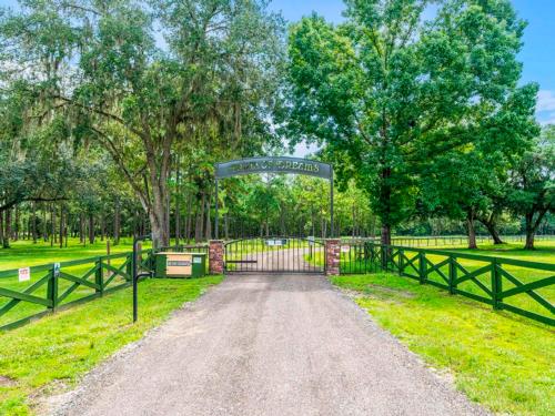 A gated grand entrance with arched sign at FARM OF DREAMS RESORT