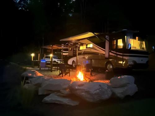 RV parked near fire pit at The Barlow RV Park