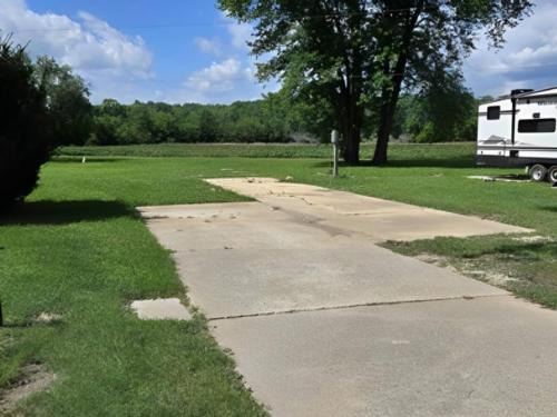 Open RV space near grass area at Birch Creek RV Park
