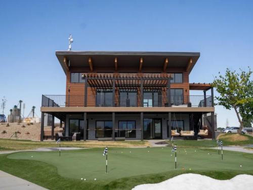 Golf putting green in front of building at GOPHER GULCH RV & CAMPGROUND