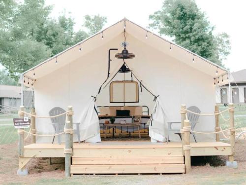 A white glamping tent with a deck at Timberline Glamping at Lake Guntersville