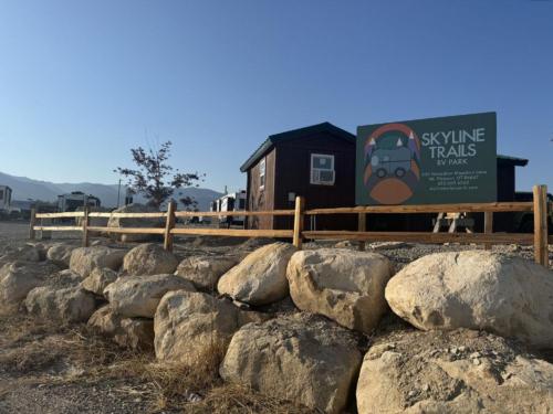 Park sign in front of a building at SKYLINE TRAILS RV PARK