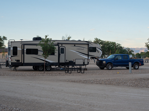 Travel trailer parked at site at Nine Mile RV Resort