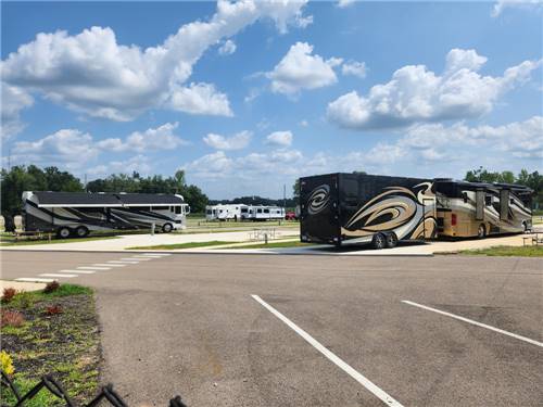 Two Class A motorhomes at sites