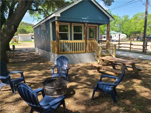 A rental cabin and seats around a fire ring