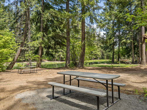 Picnic tables at site at Lake Sena Campground at Circle 8 Ranch