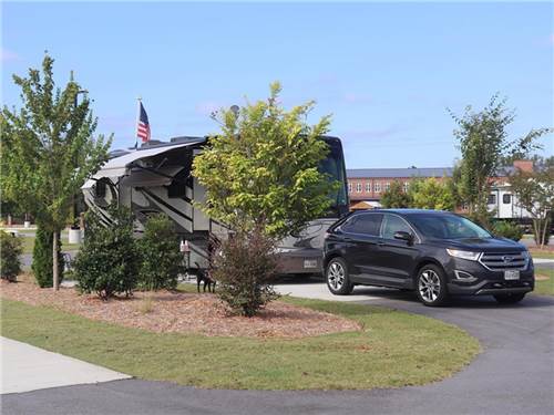 An RV and tow vehicle at a site