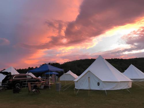 Sun setting over tents at site Adirondack Safari