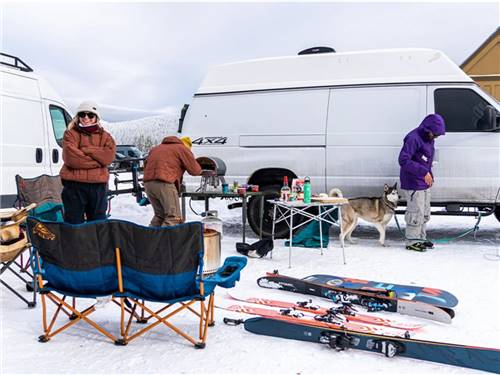 Parked RVs in winter with people and dog