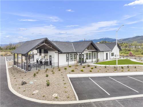 Exterior of building with outdoor grills and tables.