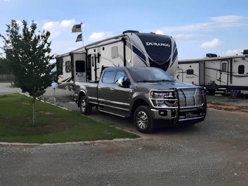 Parked trailer near pickup truck at Aviator RV Park