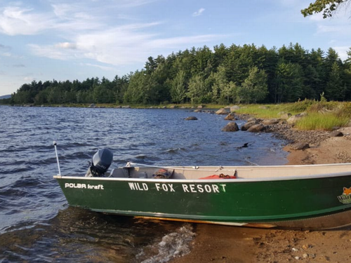 Boat by the water Wild Fox Cabins & Campground