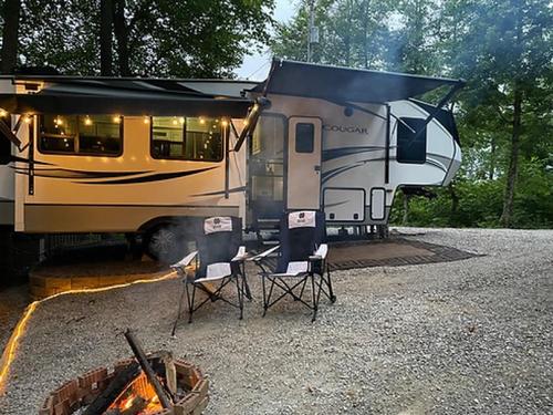 Parked trailer with fire pit at Camper Hollow RV Park and Campground