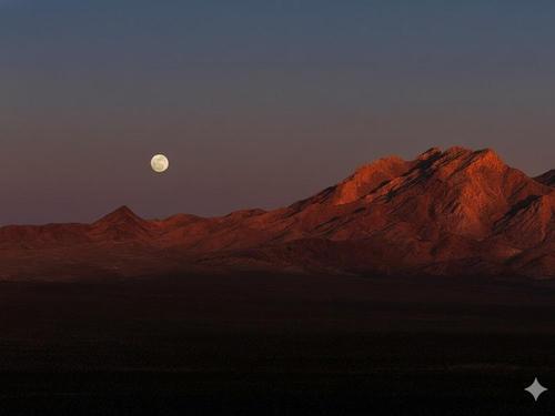 Full moon in sight as sun is setting at Tecopa Hot Springs Campground