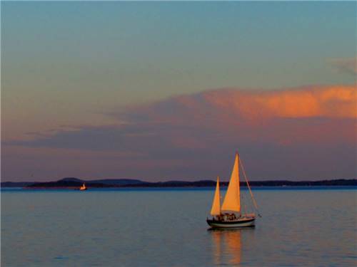 A sailboat on the ocean at dusk