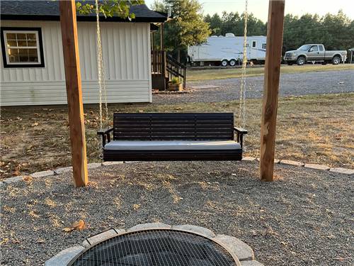 A fire pit and swinging bench