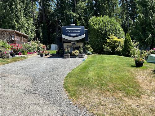 An RV in a gravel site with landscaping