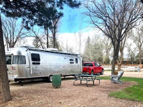 Parked trailer with red pickup truck at site La Veta Pines RV Park