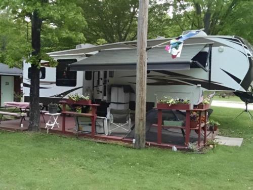 Parked trailer with covered patio at Indian Lake RV Resort