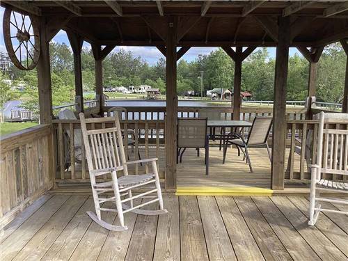 A covered seating area by the water at DIAMOND LAKE RV PARK