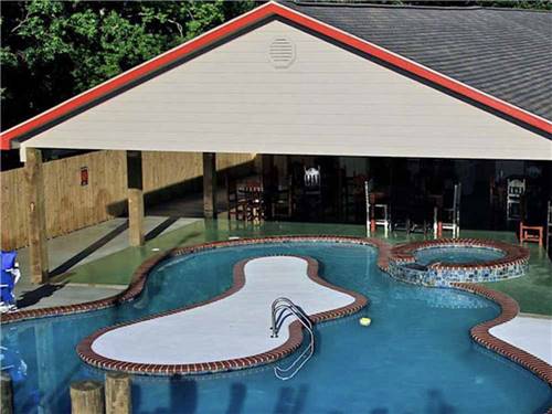 The swimming pool with an island at BEYONDER RESORT CAJUN MOON