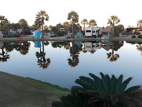 Lake view with parked trailer's at site Gulf Waters Beach Front RV Resort