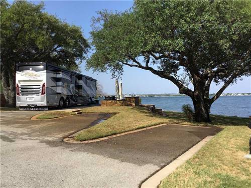 Class A Motorhome parked on-site near Lake LBJ at SUNSET POINT ON LAKE LBJ