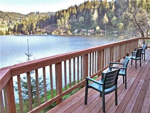 A wooden deck overlooking the water at LOON LAKE LODGE & RV RESORT