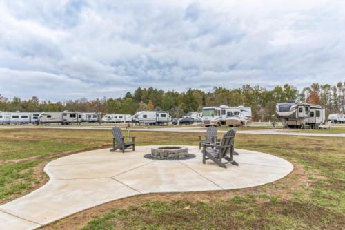 Fire pit with chairs at The Backyard RV Resort