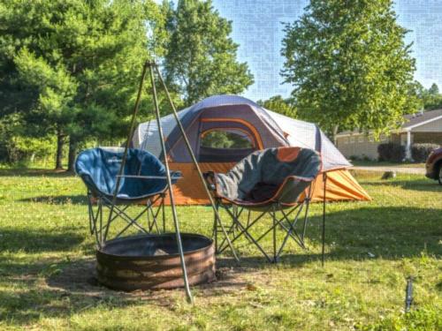 Tent next to fire pit at site North Port Huron Jellystone Park