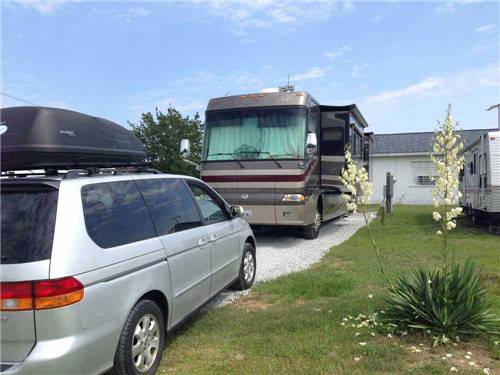 RV parked at campsite at FOUR OAKS LODGING & RV RESORT