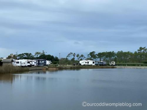 Lake with RV's parked near by at site The Refuge on Roanoke Island