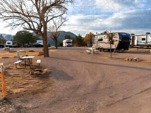 RVs parked in sites with tables at Royal Gorge RV Resort & Cabins