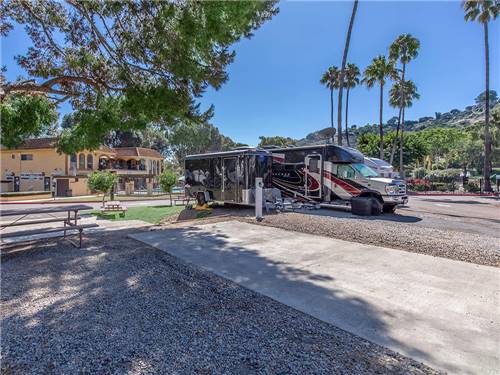 RV and trailer parked by a paved site
