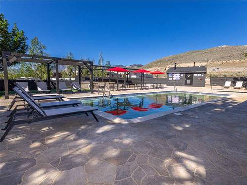 The swimming pool with lounge chairs at COMSTOCK COUNTRY RV RESORT