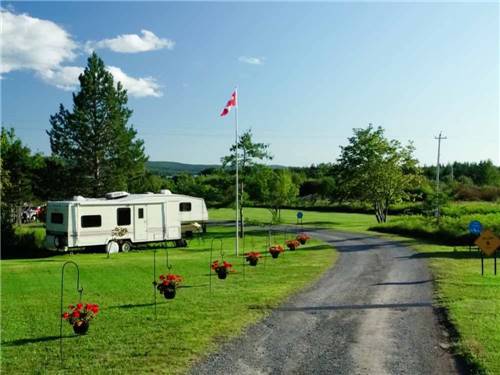 The road into the campground with flower baskets hanging at BRAS D'OR LAKES CAMPGROUND ON THE CABOT TRAIL